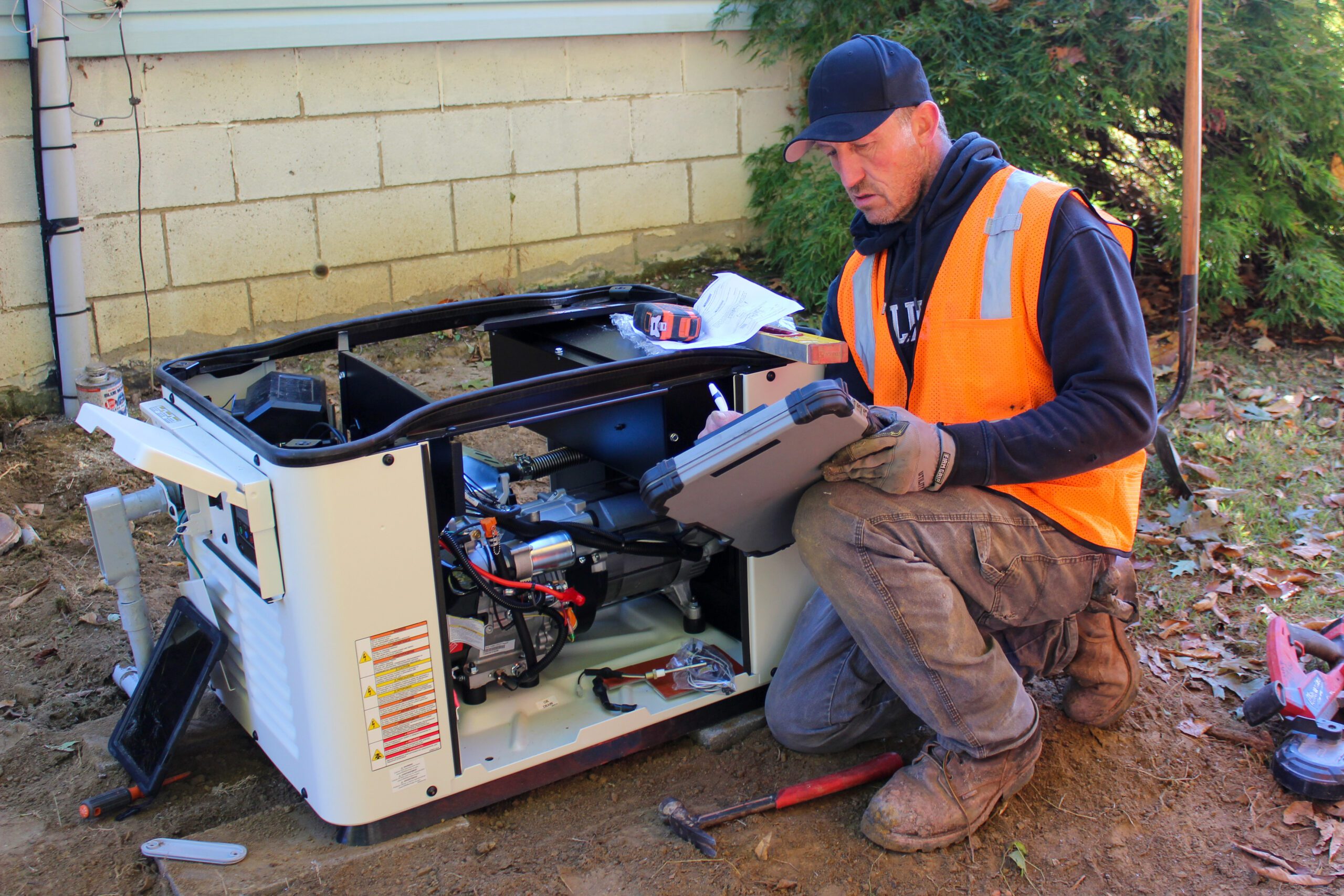 Experienced electrician reviewing installation manual for generator installation
